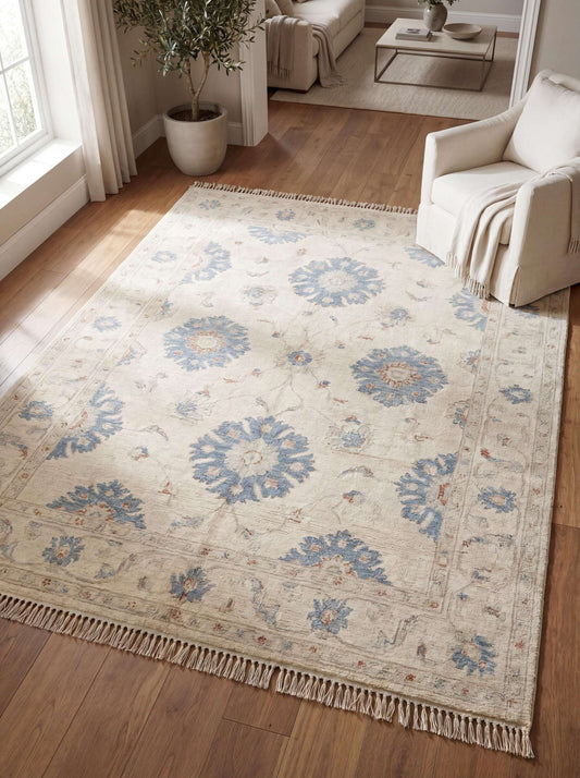 Hand knotted Oushak rug in ivory with blue floral motifs styled in modern living room on wood flooring __etsy:8005562683