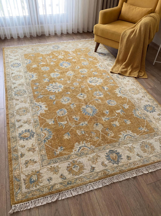 Mustard gold hand knotted Oushak rug with soft blue floral pattern placed in bright living room interior __etsy:7855078991