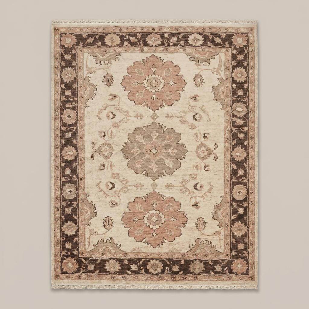 Vintage inspired floral wool carpet with mocha border and neutral beige field placed beside accent chair __etsy:8110173965