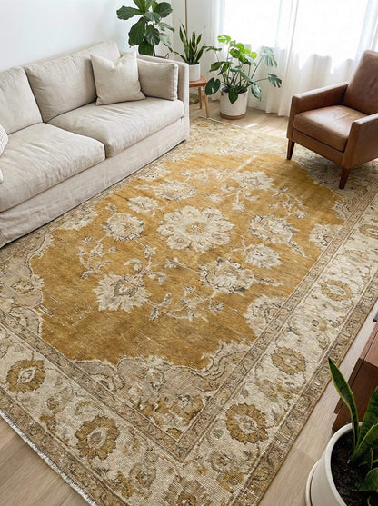 Oushak hand knotted wool rug with mustard floral design showcasing traditional craftsmanship and vintage style.