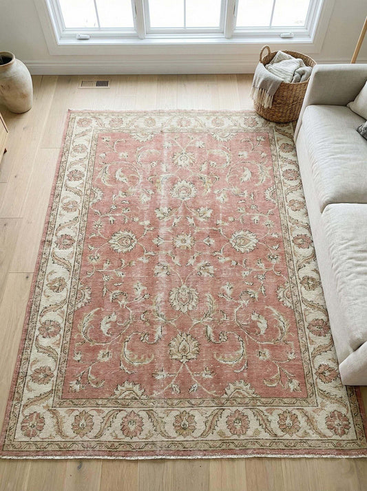 Oushak pink floral hand-knotted wool area rug with elegant border and soft pastel design