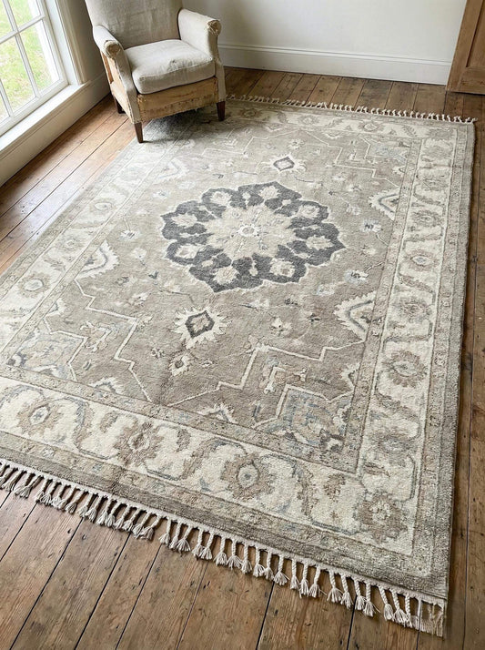 Oushak style hand knotted wool area rug with neutral medallion design and soft texture