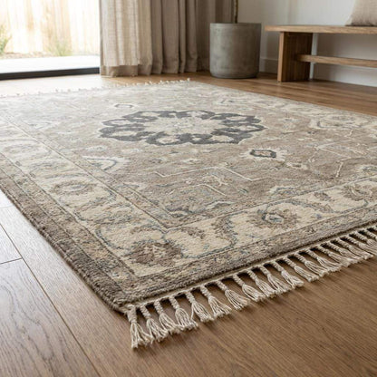 Artisan made Oushak style wool rug featuring central medallion and muted neutral tones