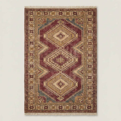 Traditional Oushak geometric rug styled in a neutral living room with stone flooring and wooden furniture