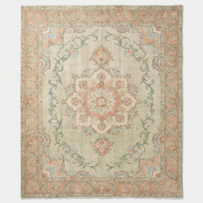 Hand-knotted Oushak style wool rug with soft green floral medallion design