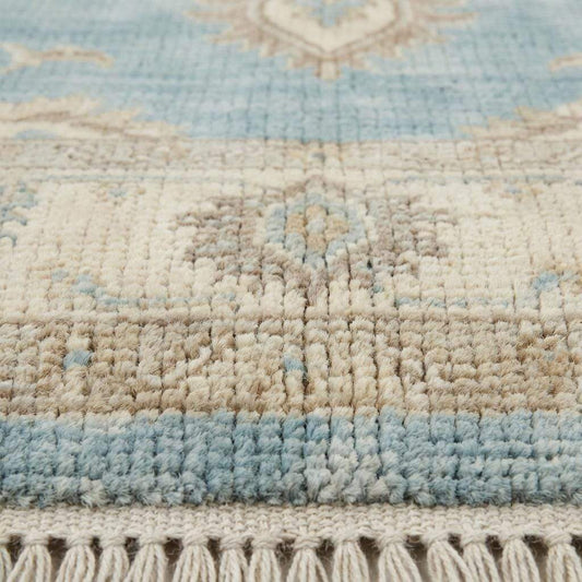 Close up of hand knotted wool pile showing dense knots, natural fibers, and soft texture