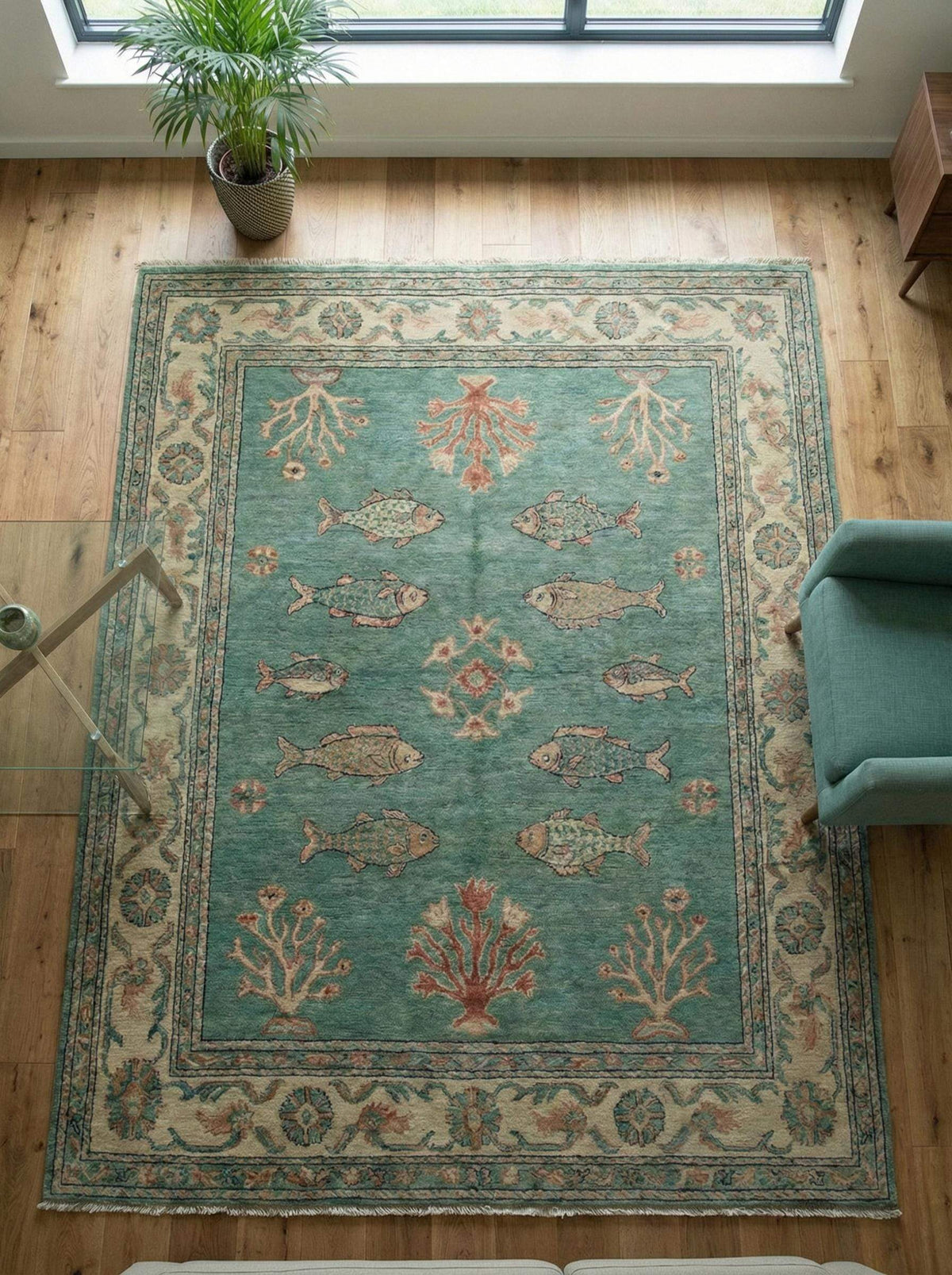 Hand-knotted Persian fish motif wool rug in teal with coral accents, artisan crafted and durable