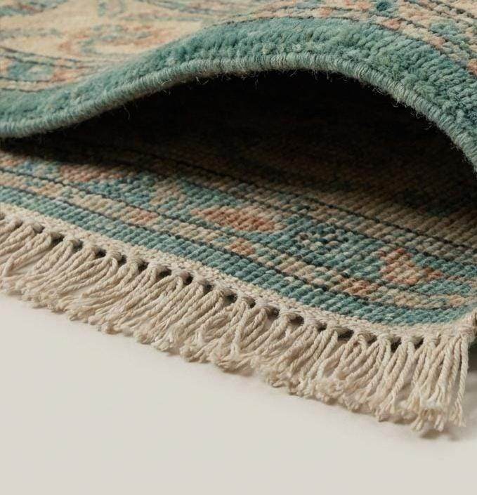 Close-up of hand knotted wool pile showing dense knot structure and natural fiber texture