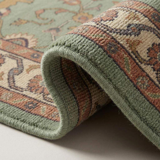 Close up of hand knotted wool rug showing dense knot structure, cut pile texture, cotton foundation, fine artisan craftsmanship detail