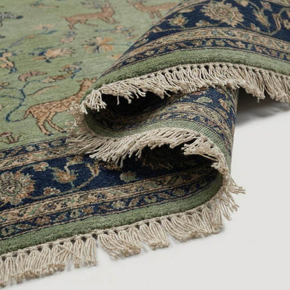 Close up of hand knotted wool pile showing detailed animal figures and knot texture