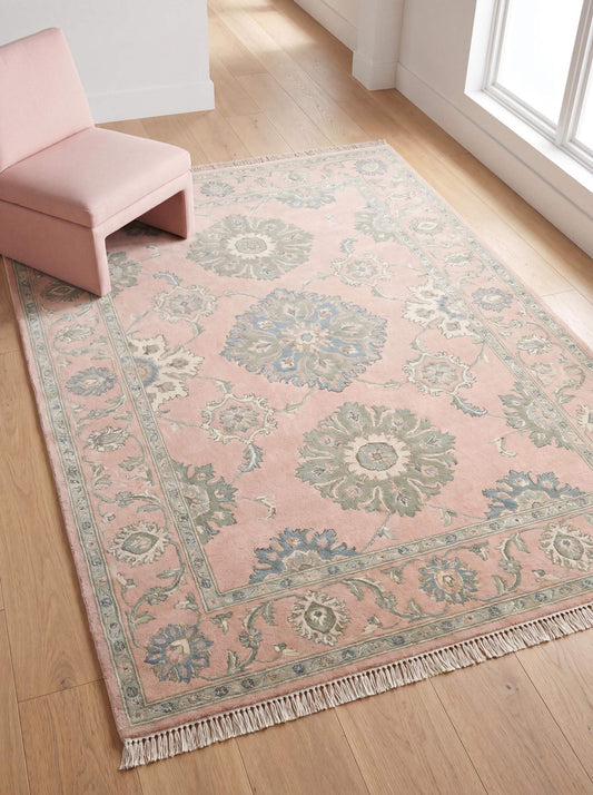 Hand knotted pink Oushak rug with floral medallion pattern placed in bright modern living room __etsy:8005575373