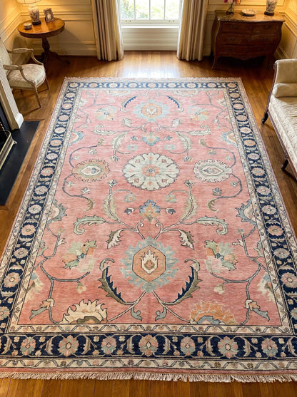 Hand knotted pink Oushak rug with navy floral border placed in elegant traditional living room interior __etsy:8071414212