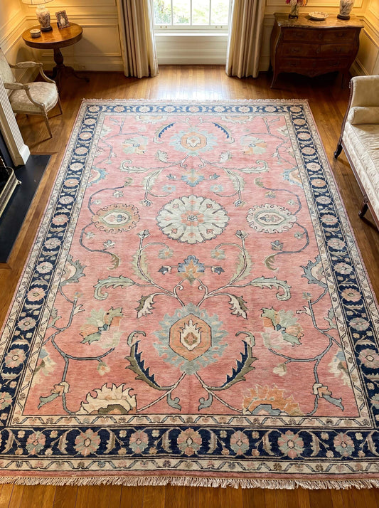 Hand knotted pink Oushak rug with navy floral border placed in elegant traditional living room interior __etsy:8071414212