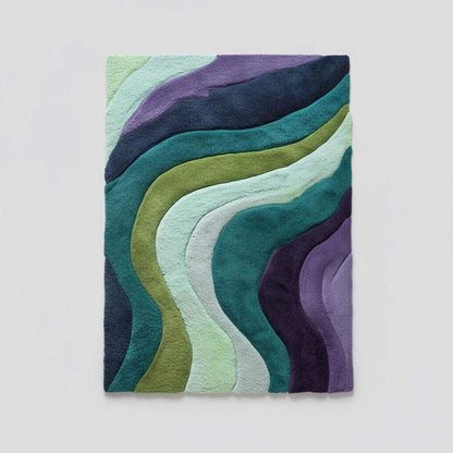 Hand tufted retro area rug with teal aqua geometric wave pattern and plush soft texture