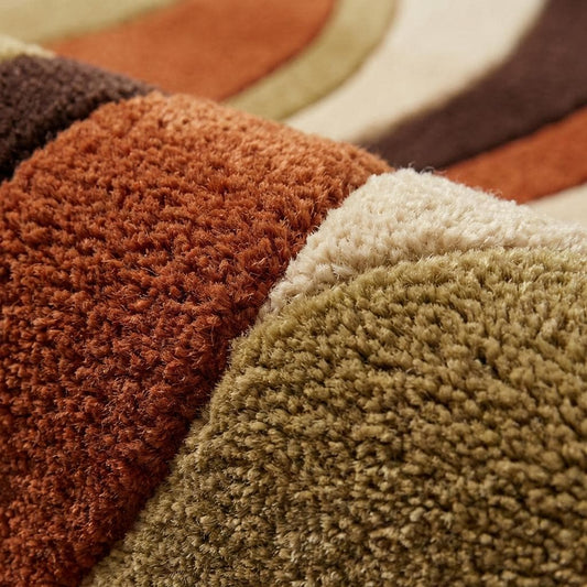 Hand-tufted retro 70s wavy area rug in burnt orange, brown, and cream with plush wool pile and mid-century modern design