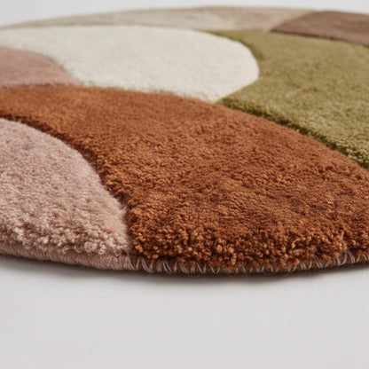 Round retro geometric wool rug with thick pile and earth tone colors