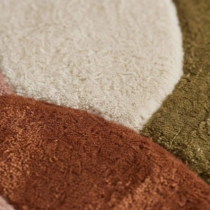 Round retro geometric wool rug with thick pile in earthy tones for cozy living room decor