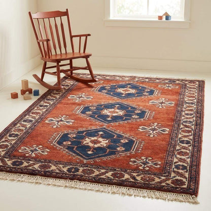 Rust red tribal hand knotted wool rug with geometric Kazak design for living room decor