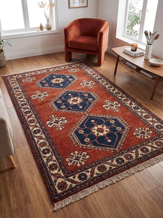 Rust red tribal hand knotted wool rug with geometric Kazak design for living room decor