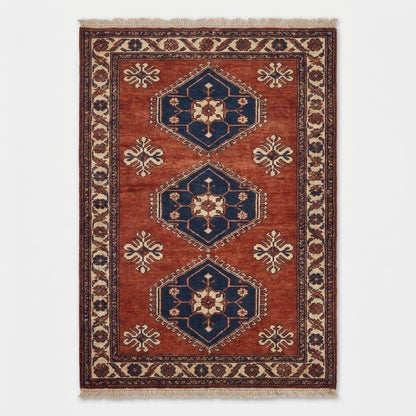 Rust red tribal hand knotted wool rug with geometric Kazak design for living room decor