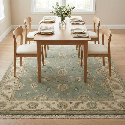 Sage green hand-knotted Oushak wool rug with muted floral design and fringe, authentic Turkish style for living room decor