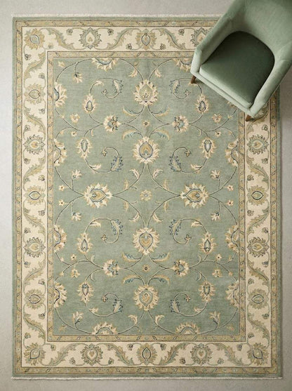 Sage green hand-knotted Oushak rug with muted floral motifs and authentic Turkish wool craftsmanship