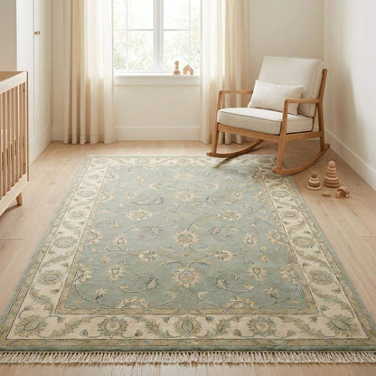 Sage green hand-knotted Oushak wool rug with muted floral design for living room decor