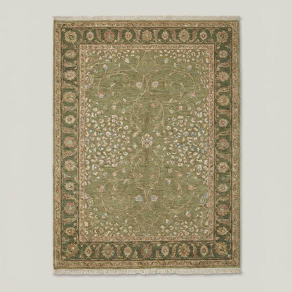 Traditional Oushak style wool rug with muted green field and decorative floral border