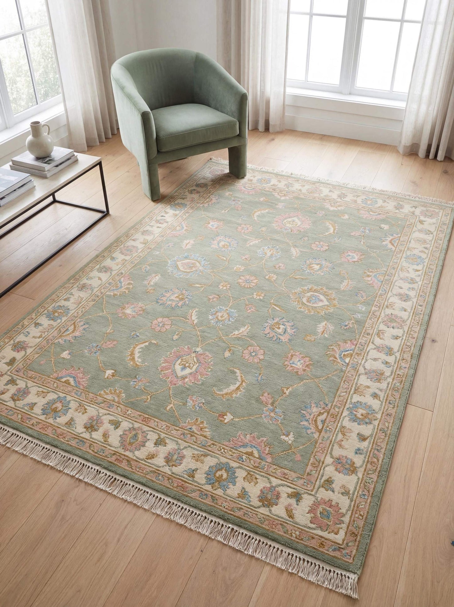 Hand knotted sage green Oushak rug with floral vines and traditional border placed in a bright living room interior __etsy:7784990970