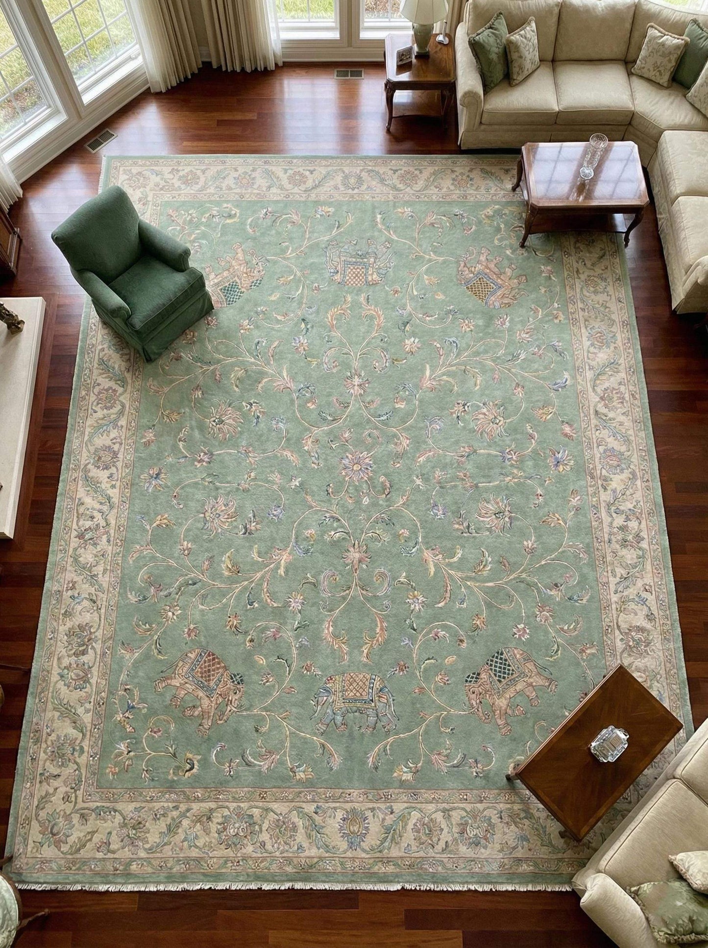 Sage green Persian wool area rug with hand-knotted floral and elephant motifs