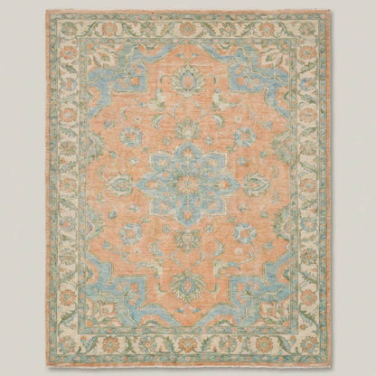 Traditional Oushak wool rug styled in bright living room with wooden floors