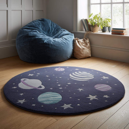 Space theme round rug with astronaut and planet design in navy wool nursery decor