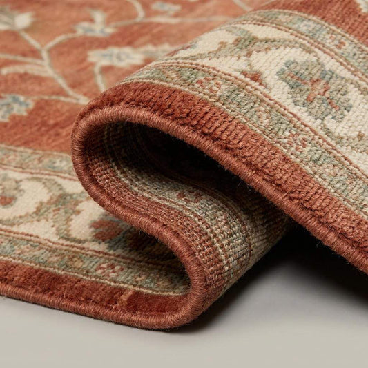 Close-up of hand knotted wool rug texture showing individual knots, soft pile, and floral detailing in terracotta and sage tones __etsy:7970288491