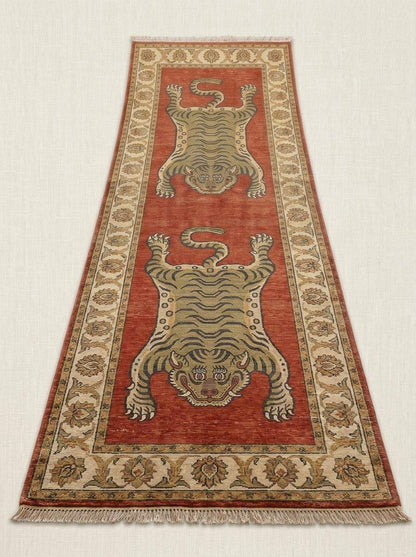 Traditional Tibetan tiger wool runner carpet with bold animal artwork, rust red field, and ivory floral border for hallway décor. __etsy:8100396218