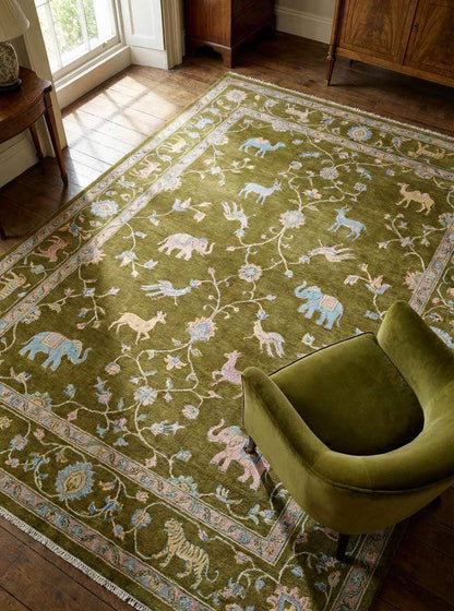 Tree of Life hand knotted wool area rug with animal motifs and rich green field