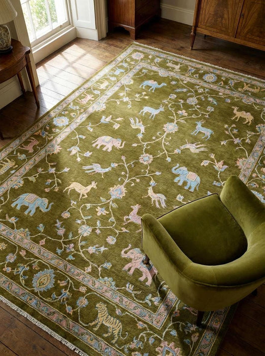 Hand knotted wool Tree of Life area rug with animal motifs on green background