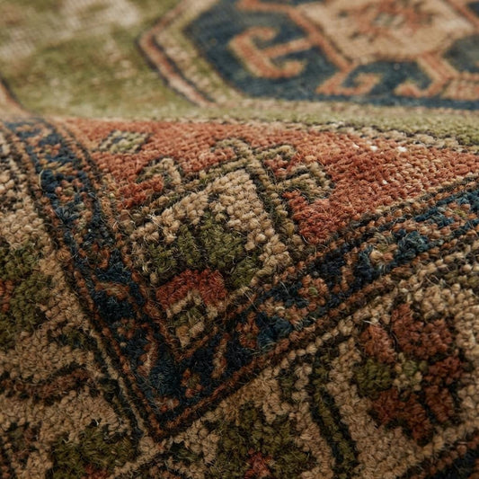 Close-up of hand knotted wool rug showing dense pile, natural wool fibers, and individual knot texture.