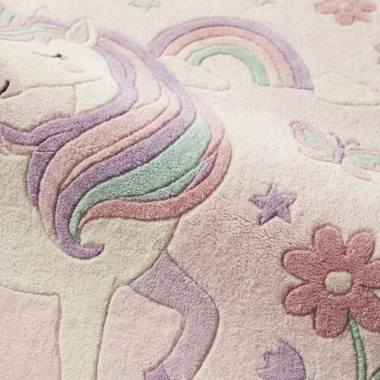 Close-up of plush pastel unicorn rug fibers showing soft tufted texture, raised design details, and cushioned pile for nursery or kids room flooring