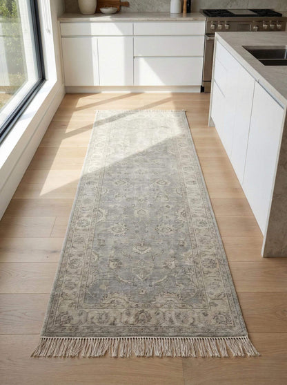 Vintage floral bordered hand-knotted runner rug in neutral gray with floral medallion pattern and hand-tied fringe edges