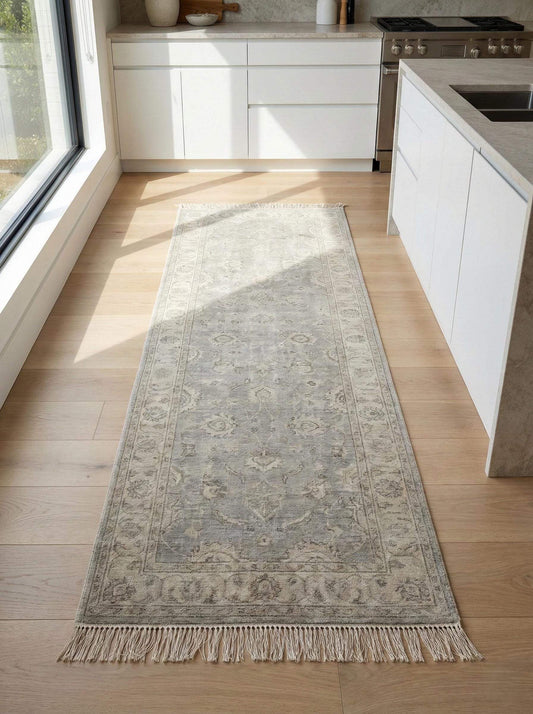 Vintage floral bordered hand-knotted runner rug in neutral gray with floral medallion pattern and hand-tied fringe edges
