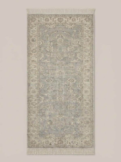 Vintage floral bordered hand knotted runner rug in neutral gray with floral medallion pattern and hand-tied fringe edges