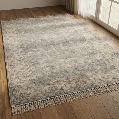Vintage floral bordered hand-knotted runner rug in neutral gray with ornate floral medallion pattern and hand-tied fringe edges