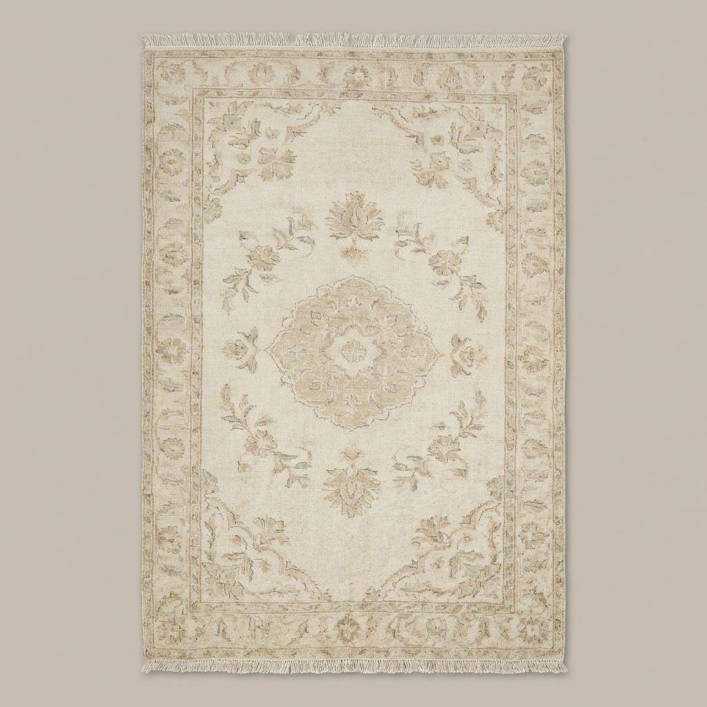 Neutral hand knotted area rug styled in a bright bedroom with wooden floors and soft natural light