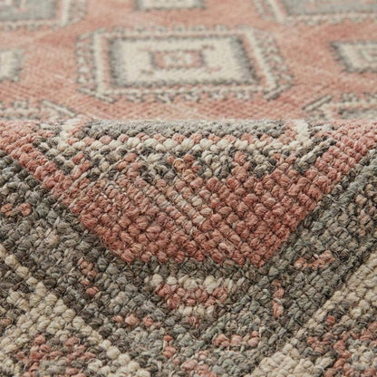 Close-up of hand knotted wool pile showing individual knots, natural fiber texture, and artisan craftsmanship.