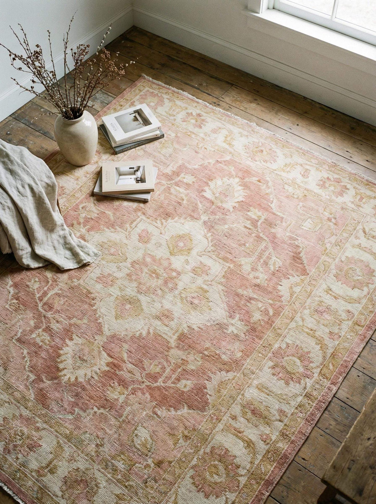 Vintage Oushak hand knotted wool rug in soft blush pink with floral motifs and durable craftsmanship