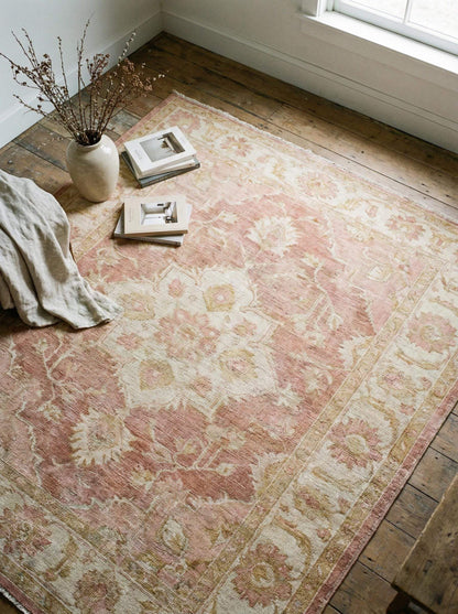 Vintage Oushak hand knotted wool rug in soft blush pink with floral motifs and durable craftsmanship