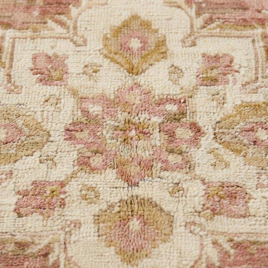 Close-up of hand knotted wool pile showing low pile texture, natural fibers, and subtle abrash variations