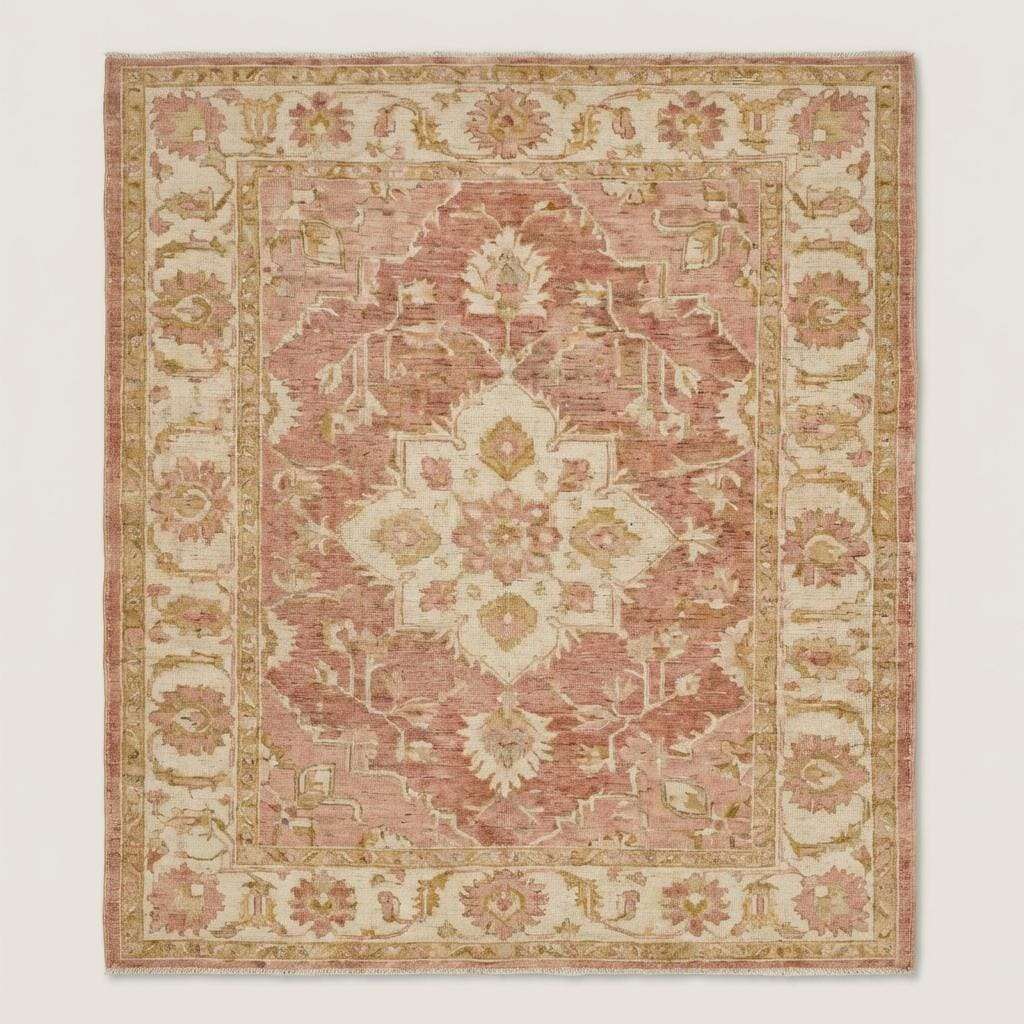 Blush pink and ivory Oushak style wool area rug with traditional floral motifs and faded vintage look