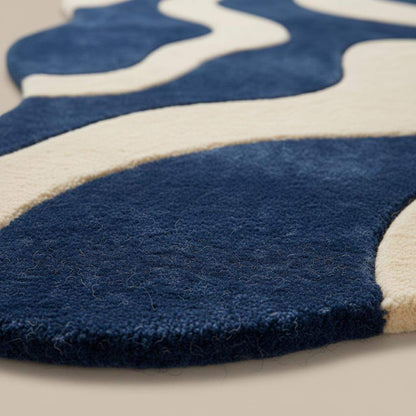 Blue cream wavy modern rug with abstract retro wave pattern and plush texture