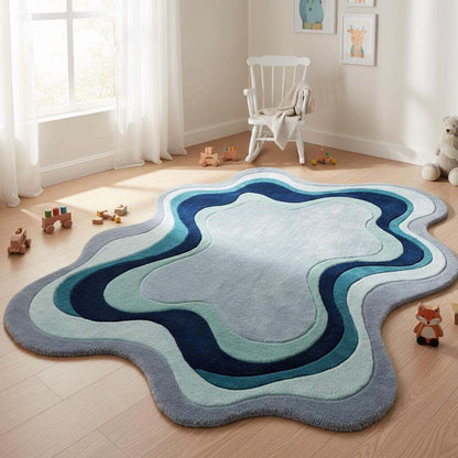 Blue abstract accent rug with soft gradient waves, enhancing a stylish sitting area with natural sunlight.